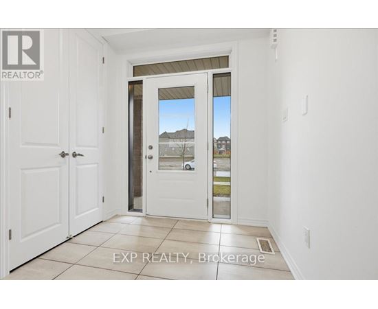 A white door with a glass window is in a room with white walls.