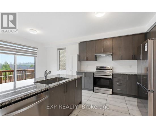 A modern kitchen with dark brown cabinets and stainless steel appliances.