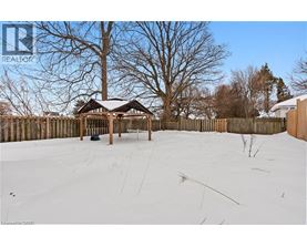 A gazebo sits in the middle of a snow-covered field.