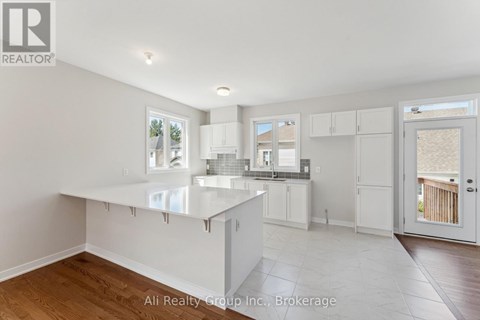 A spacious kitchen with white cabinets and a large island.