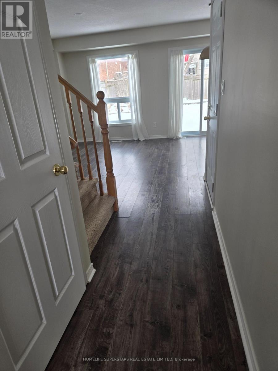 A hallway with wood floors and white walls.