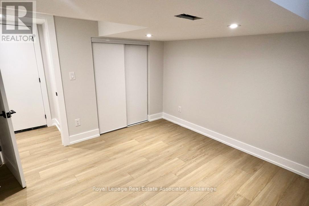 A room with a sliding door and wooden flooring.