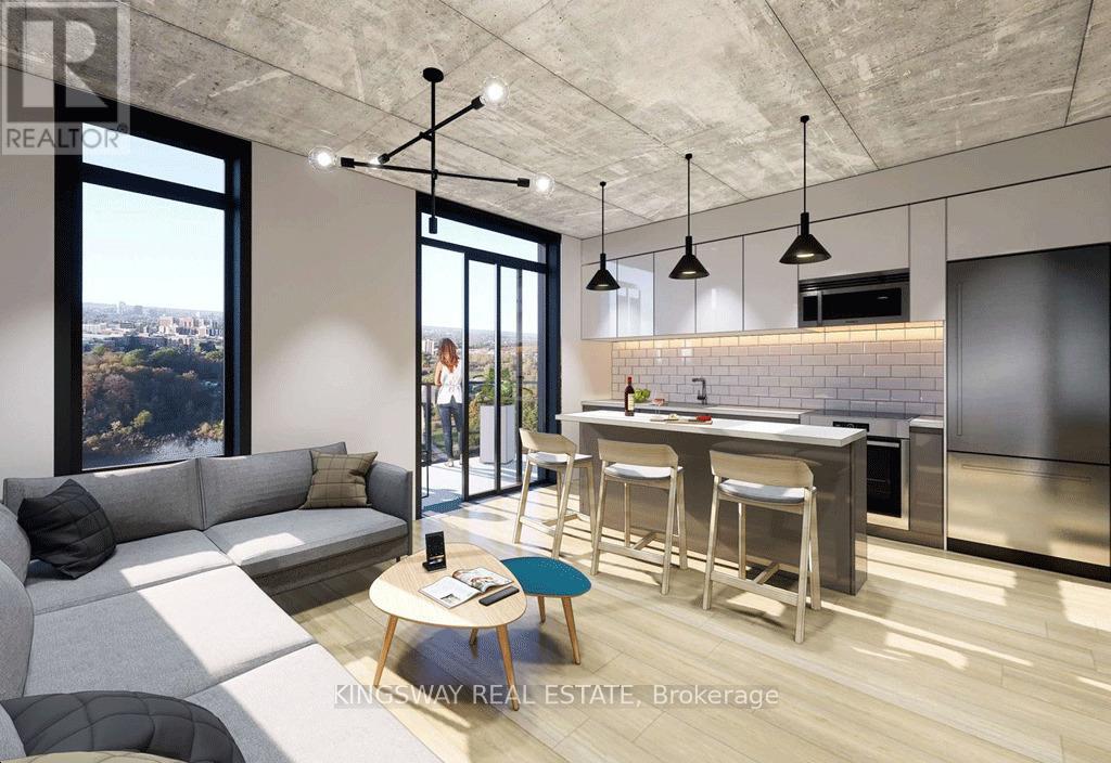 A modern kitchen with a bar stool and a table with a phone on it.