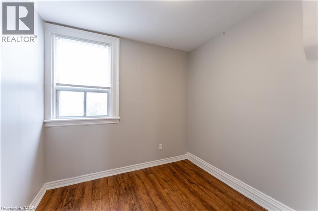 A room with a window and wooden floors.