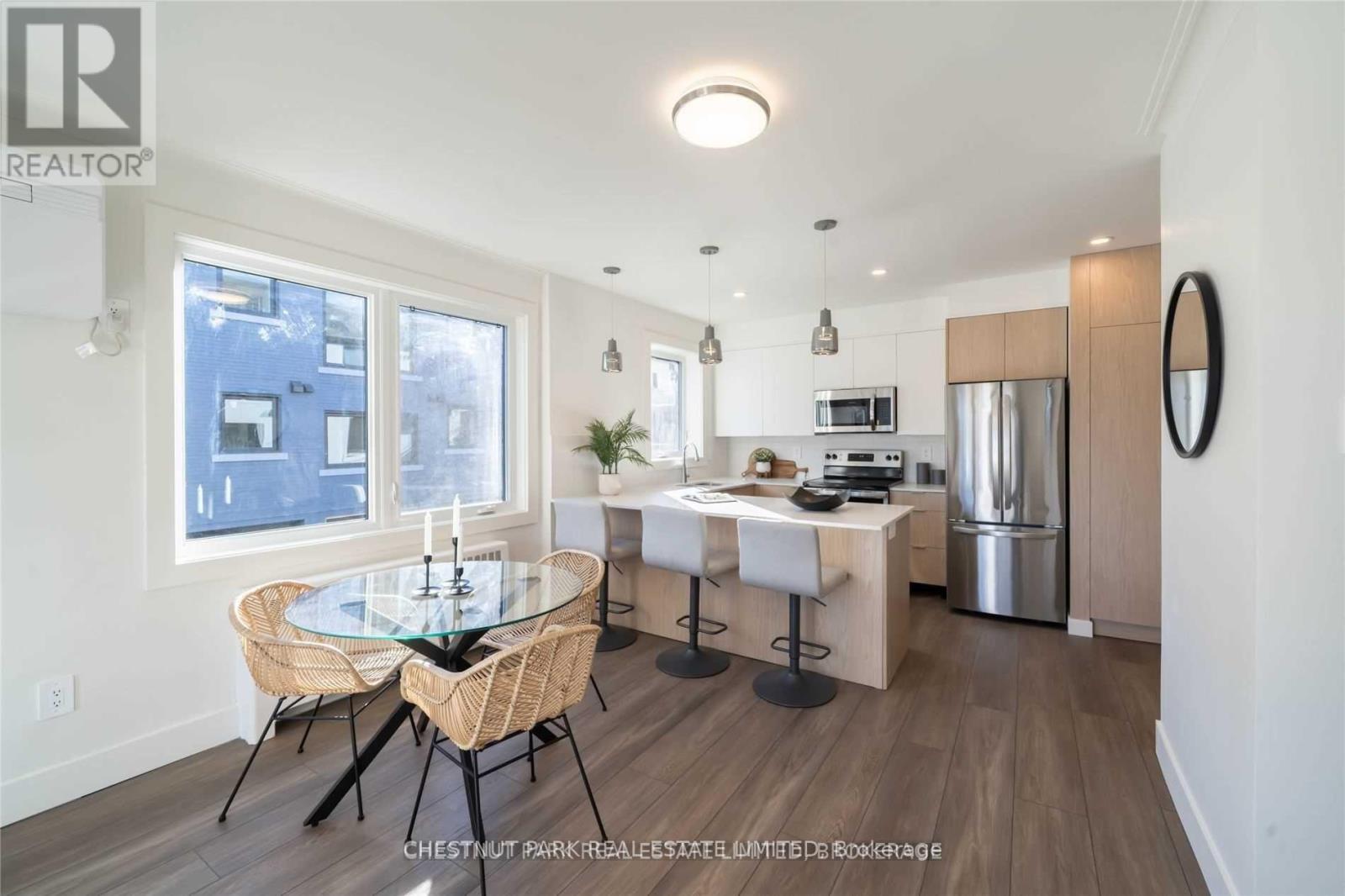 A modern kitchen with a dining table set up.