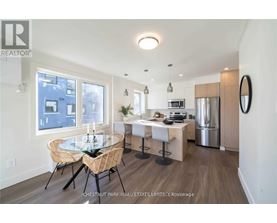 A modern kitchen with a dining table set up.