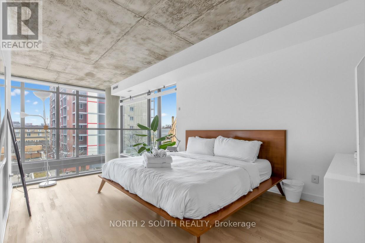 A bedroom with a large bed and a view of the city.