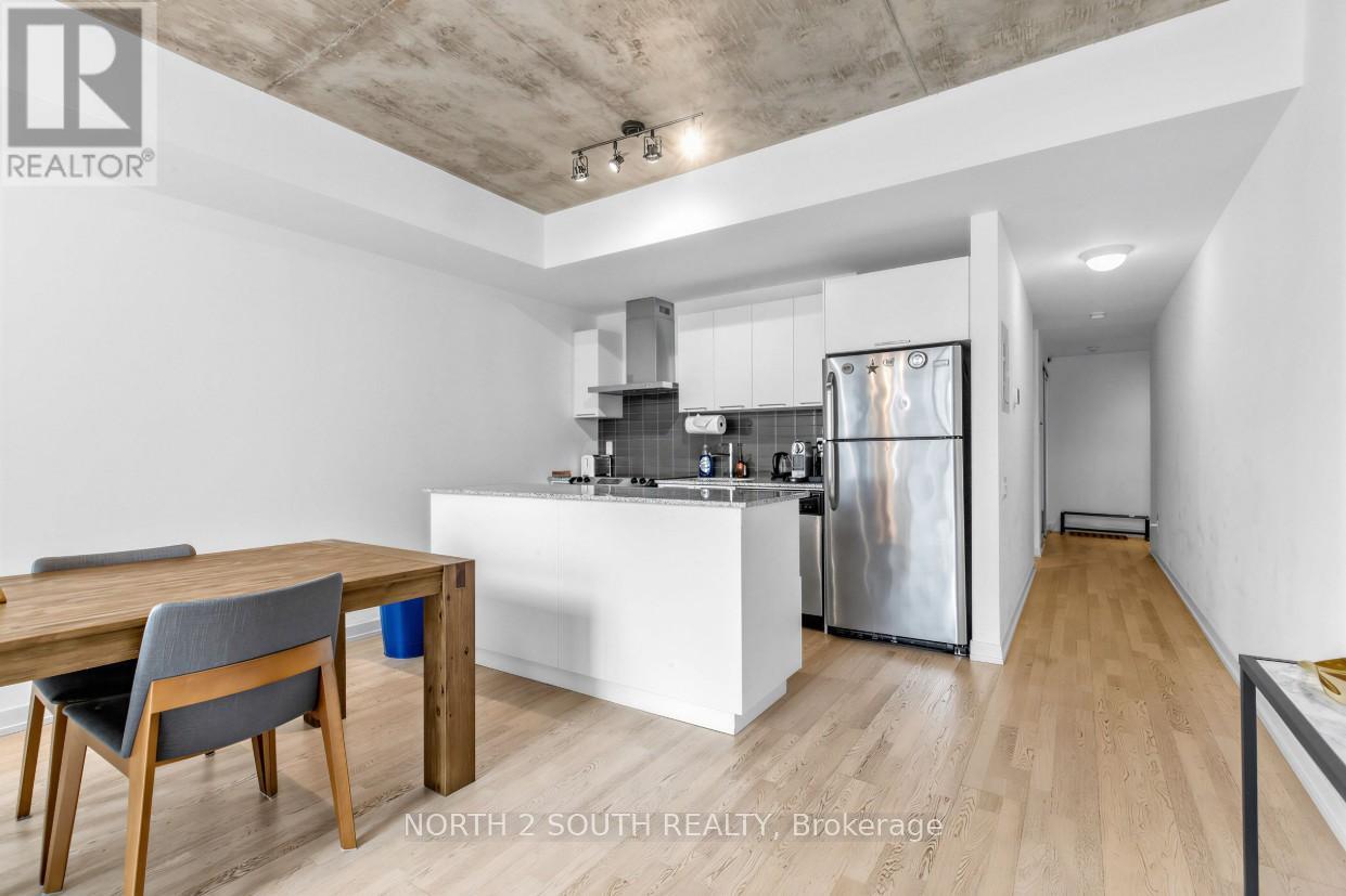 A modern kitchen with a dining table and chairs.