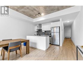A modern kitchen with a dining table and chairs.