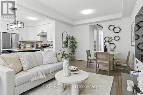 A modern living room with a white sofa and a dining table set up.