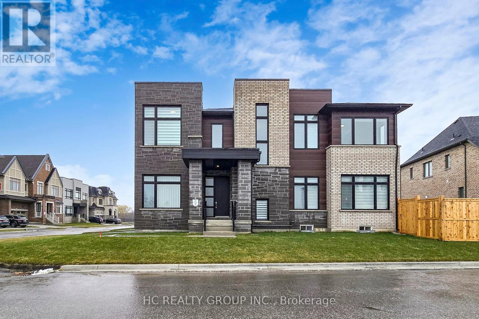 A modern two-story house with a brick facade is for sale by HC Realty Group Inc. in Brokerage.