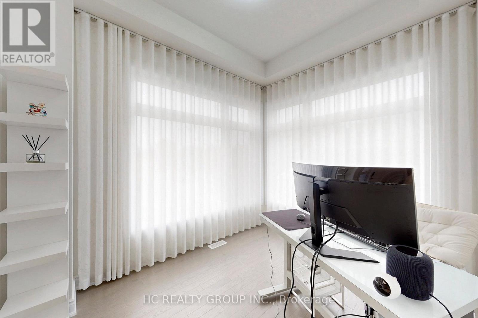 A modern living room with a television and a white sofa.