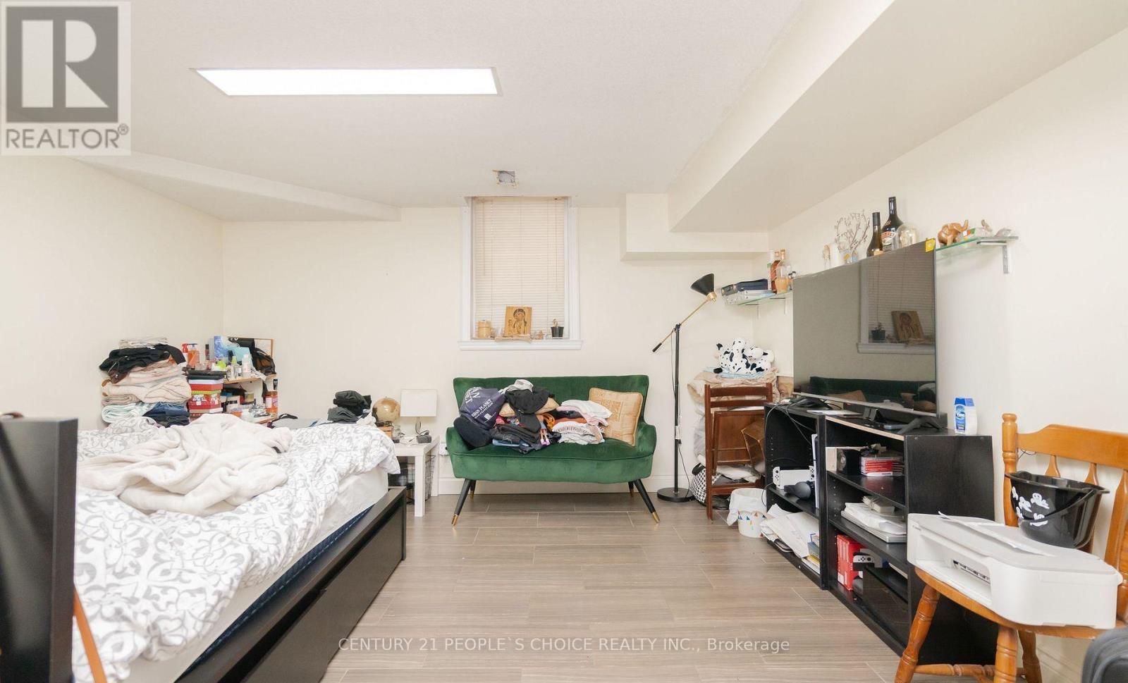 A bedroom with a bed, desk, and chair.