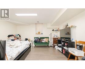 A bedroom with a bed, desk, and chair.