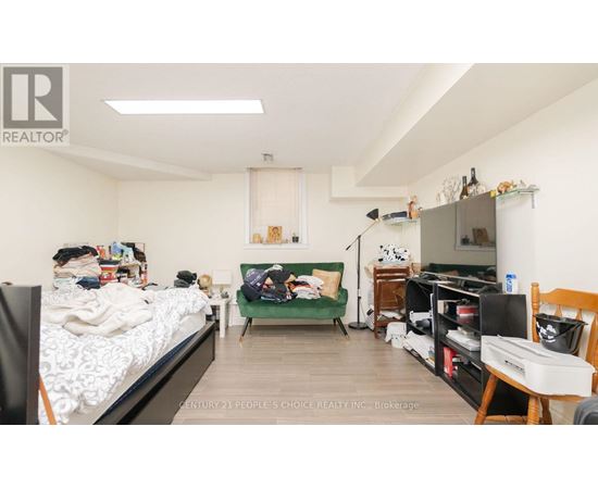 A bedroom with a bed, desk, and chair.