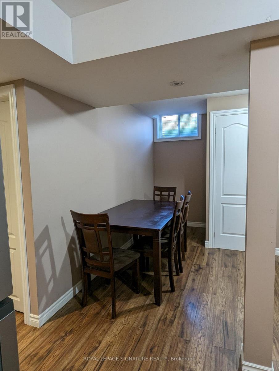 A dining room with a table and chairs.