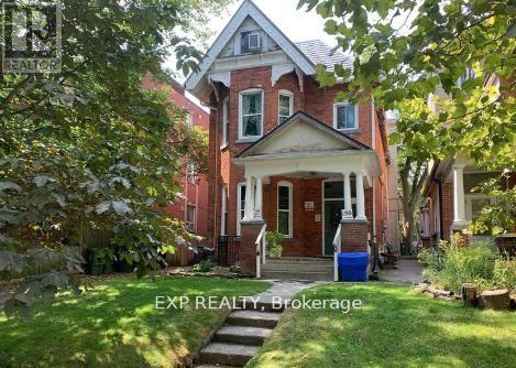 A house with a red door and a sign that says EXP REALTY Brokerage.