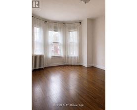 A room with wooden floors and white walls.