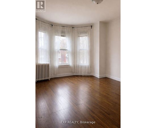A room with wooden floors and white walls.
