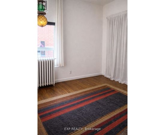 A room with a window and a radiator.