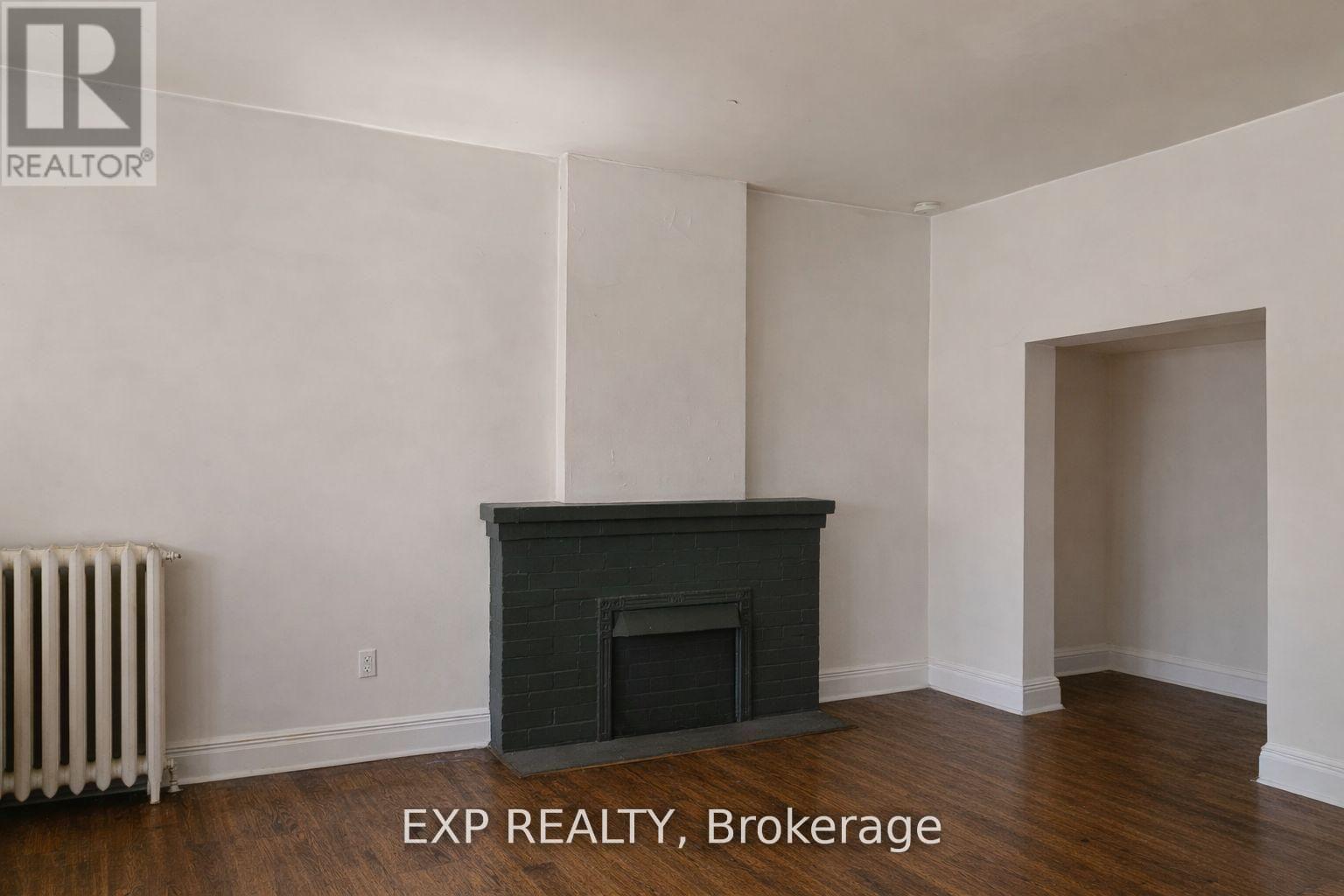A room with a fireplace and a radiator.