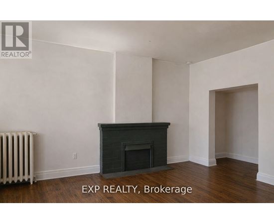 A room with a fireplace and a radiator.