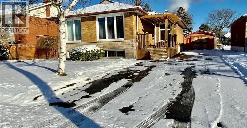 A house with a snow-covered ground in front of it.