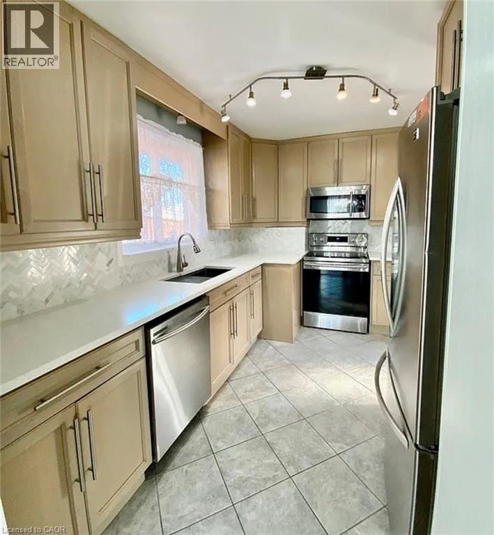 A kitchen with wooden cabinets and a refrigerator.