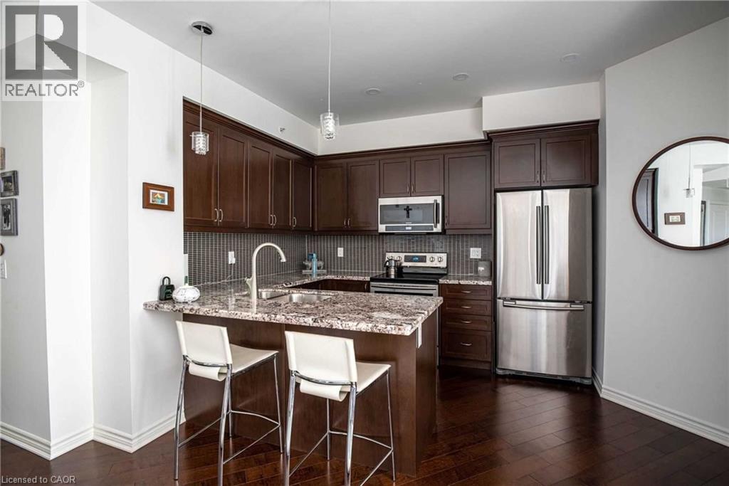 A kitchen with brown cabinets and a granite countertop.