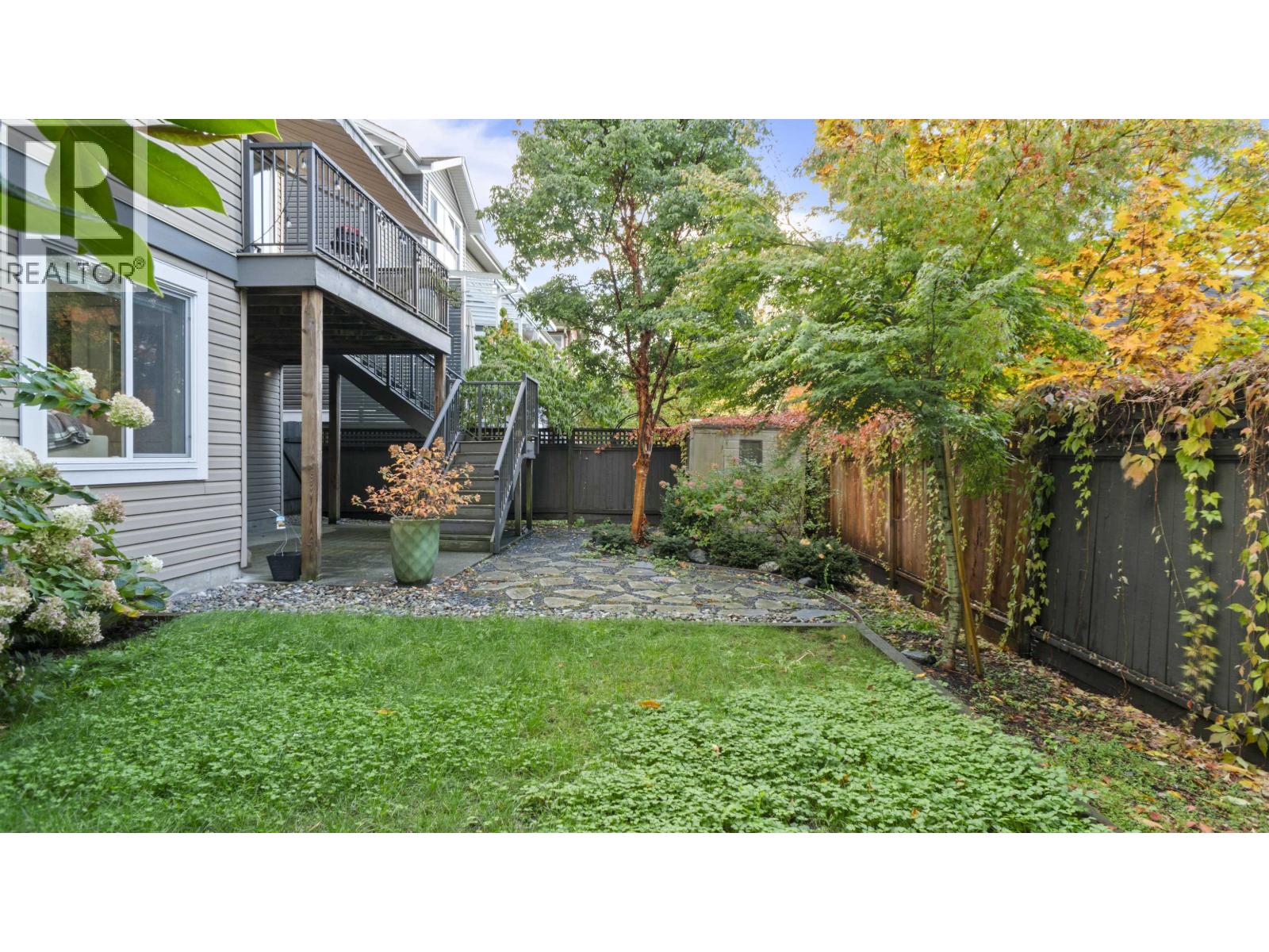 A backyard with a patio and a small garden.