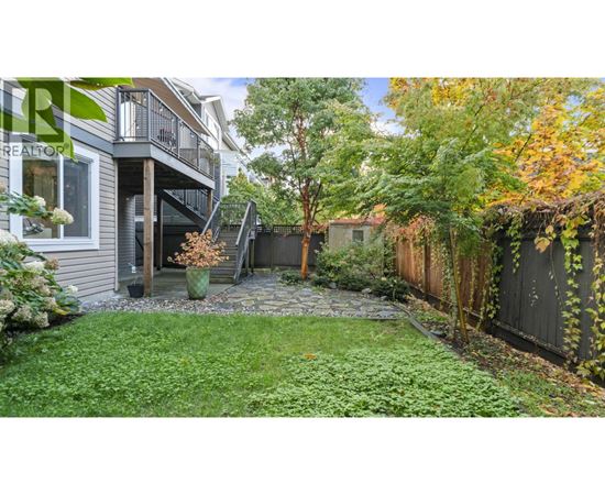 A backyard with a patio and a small garden.