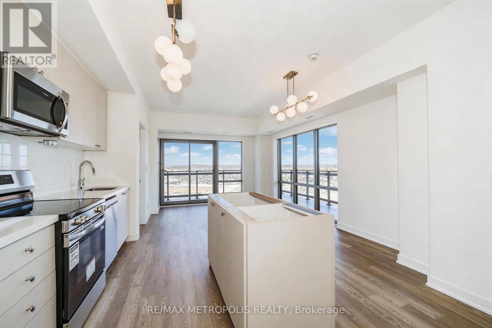 A modern kitchen with a stove top oven and microwave.