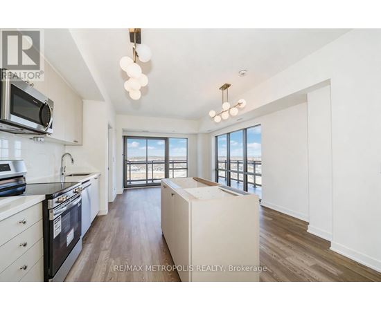 A modern kitchen with a stove top oven and microwave.