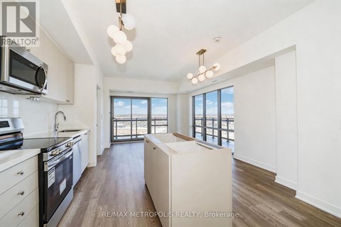 A modern kitchen with a stove top oven and microwave.