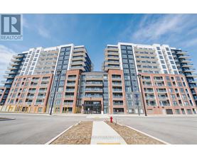 A large, modern apartment complex with multiple buildings and balconies.