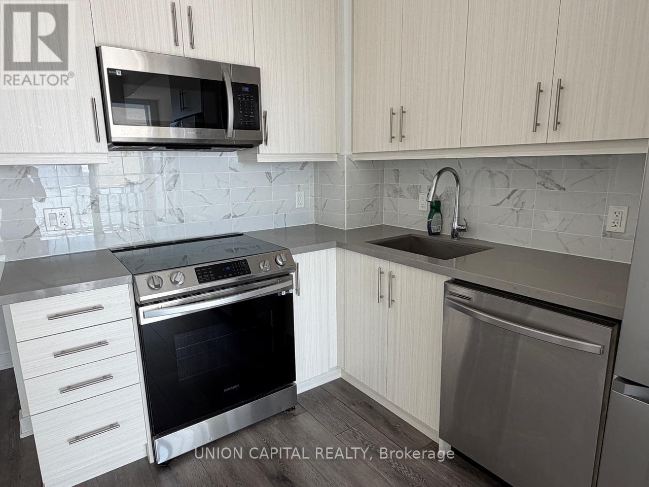 A kitchen with a stove top oven, microwave, and dishwasher.