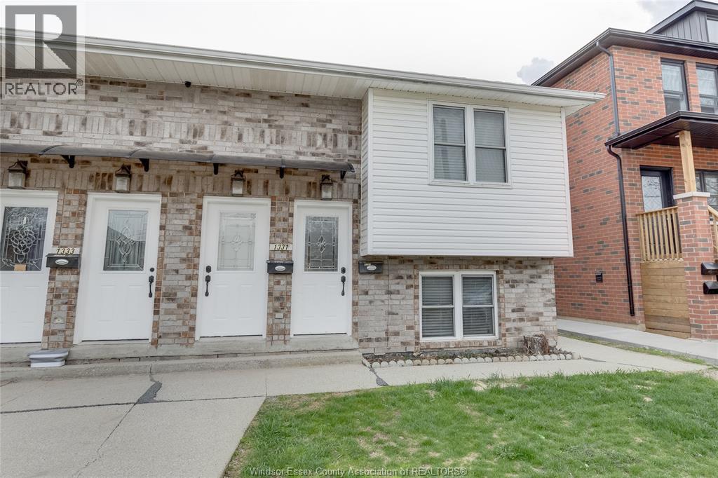 A house with a white garage door is for sale.