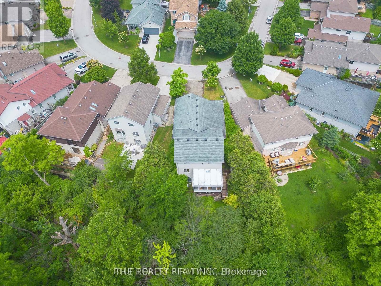 A bird's eye view of a residential area with houses and trees.