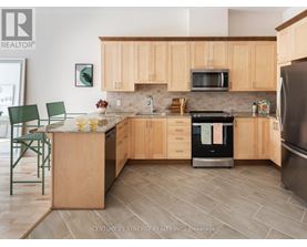A kitchen with wooden cabinets and a tiled floor.