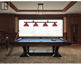 A pool table in a room with wooden walls and a window with blinds.