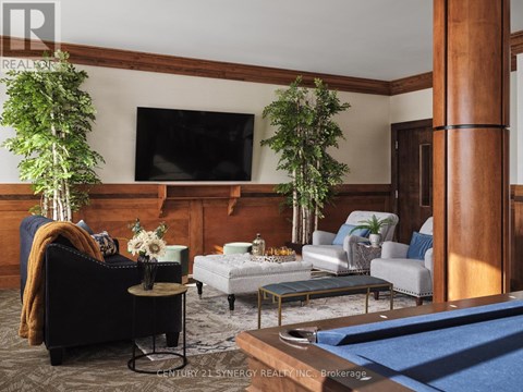 A living room with a pool table and a television.