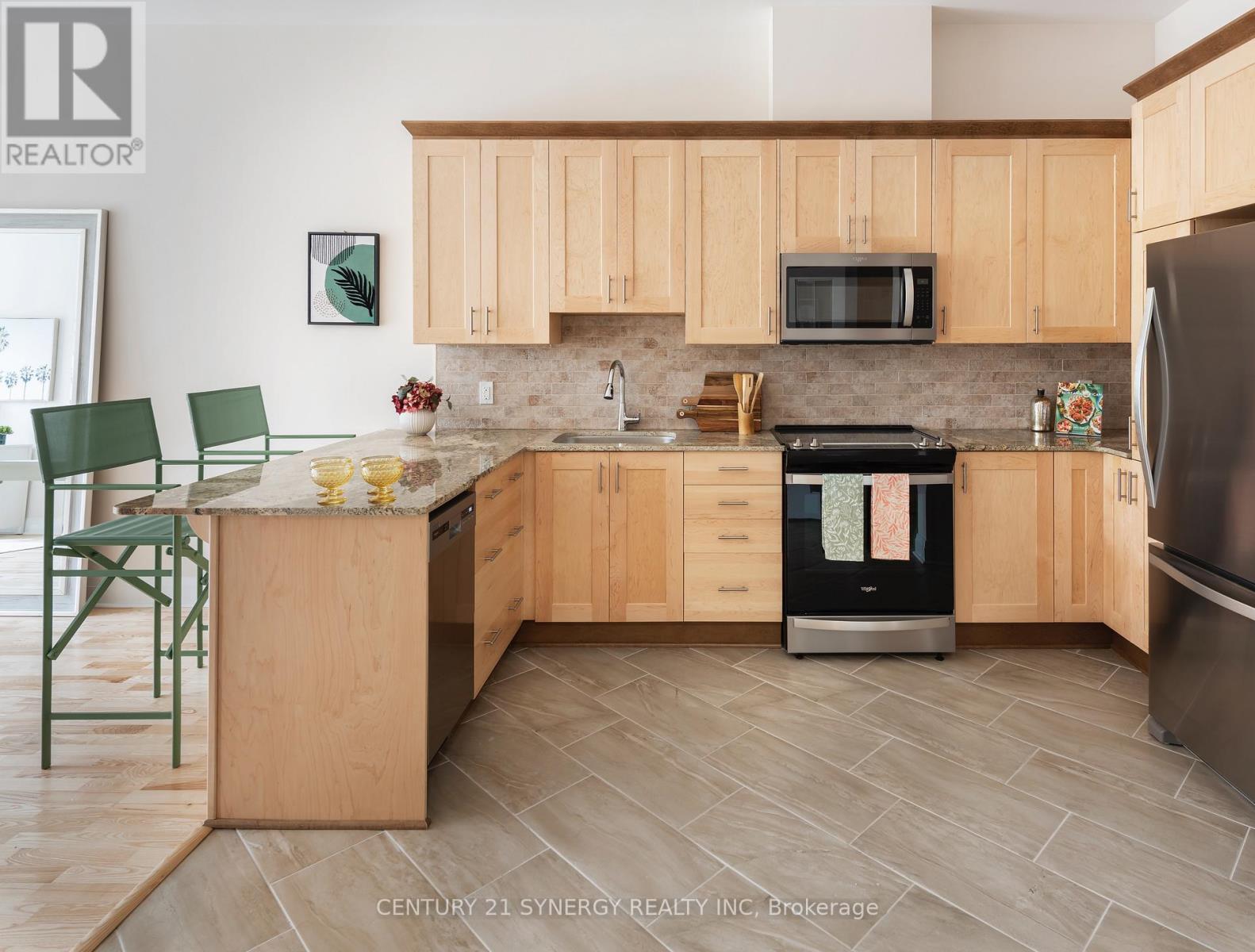 A kitchen with wooden cabinets and a tiled floor.