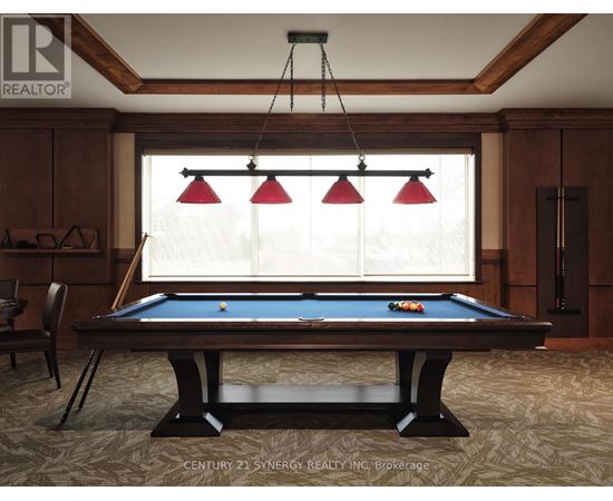 A pool table in a room with wooden walls and a window with blinds.
