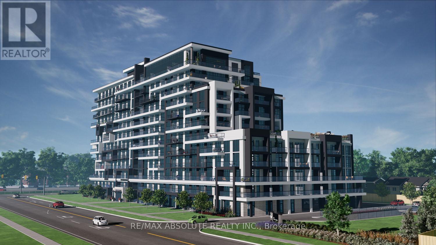 A modern multi-story building with a parking lot in front.