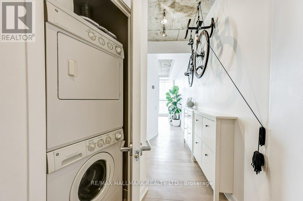A white oven is in a kitchen with a white wall.