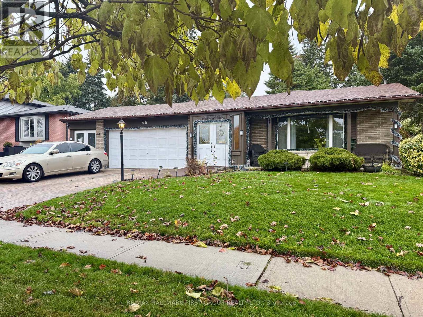 A house with a car parked in front of it.