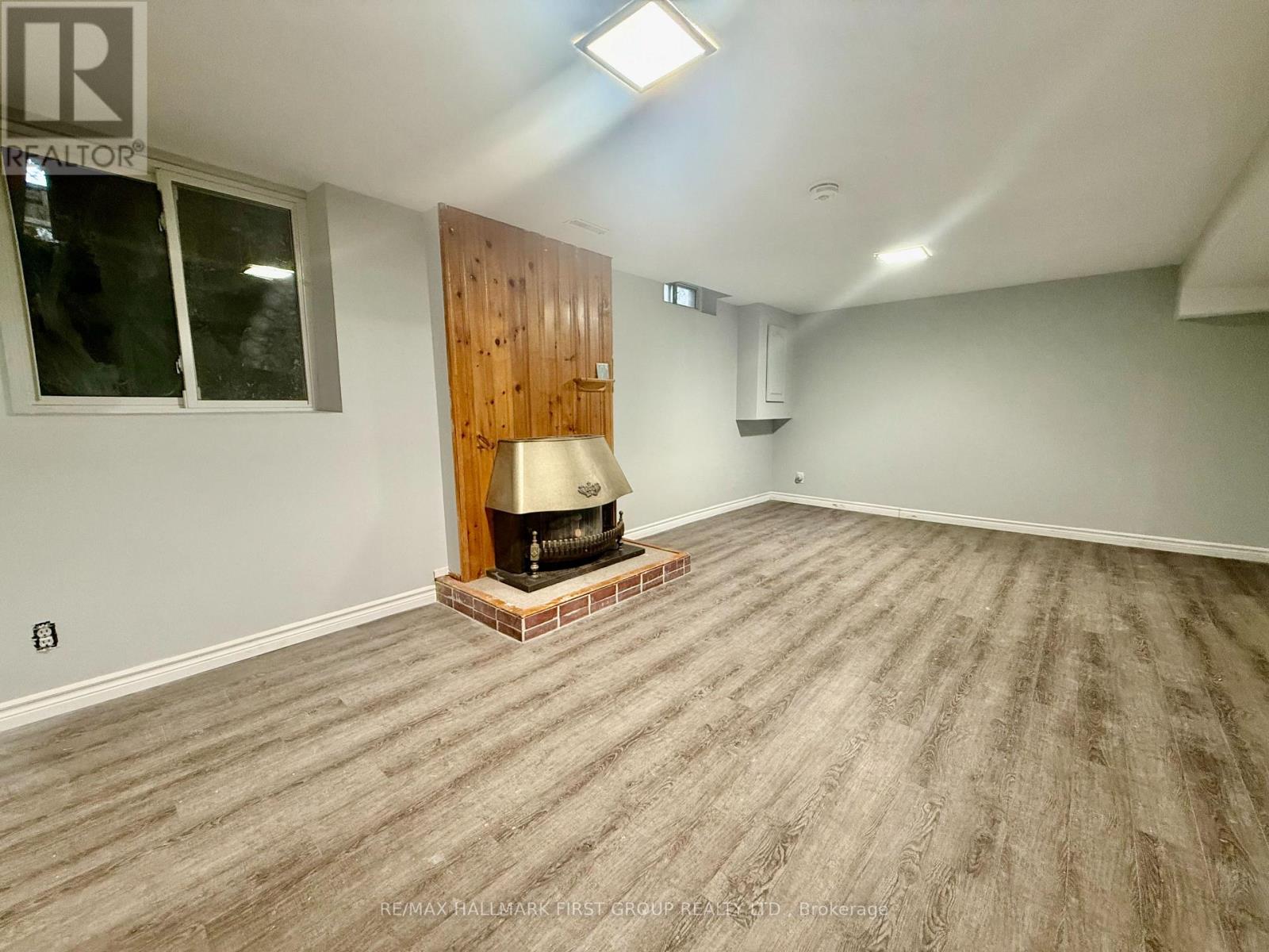 A room with a wood panelled wall and a wood floor.