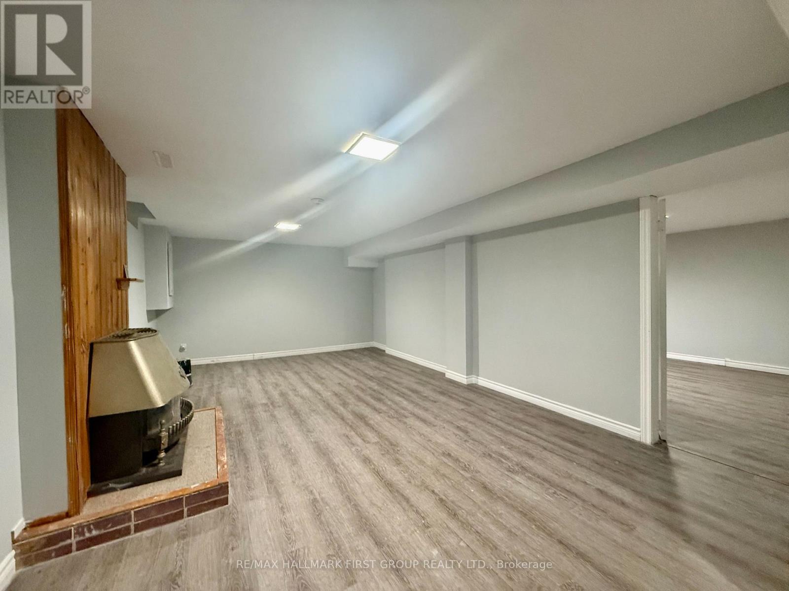 A room with a wood-burning stove in it.