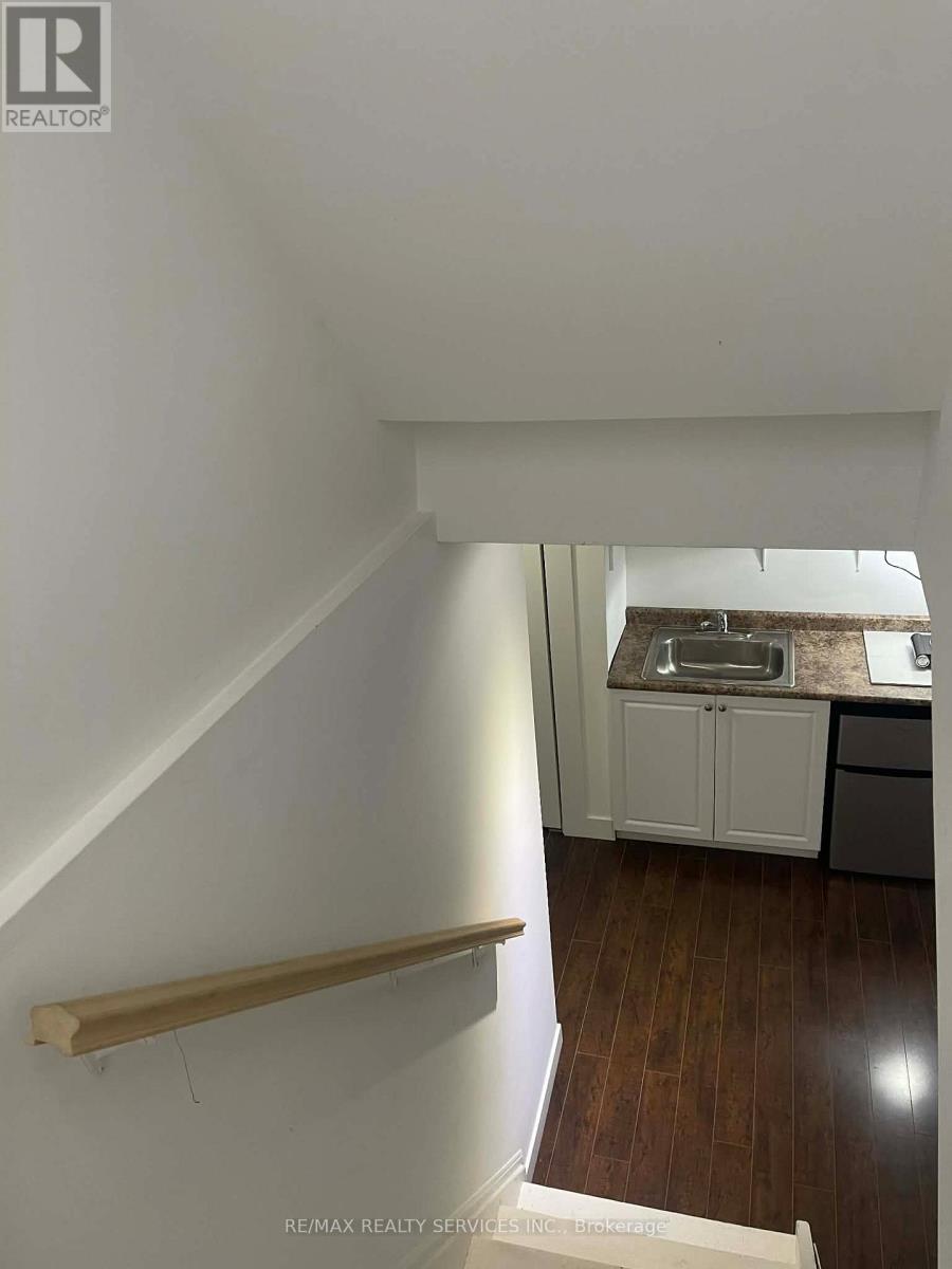A small kitchen with a sink and cabinets.