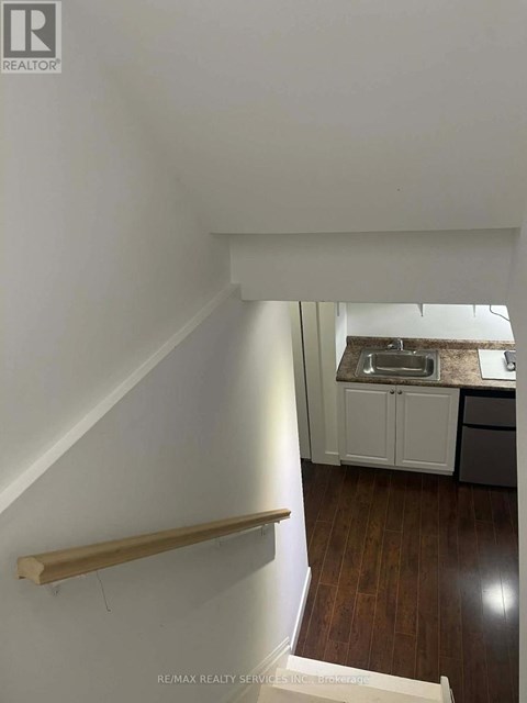 A small kitchen with a sink and cabinets.